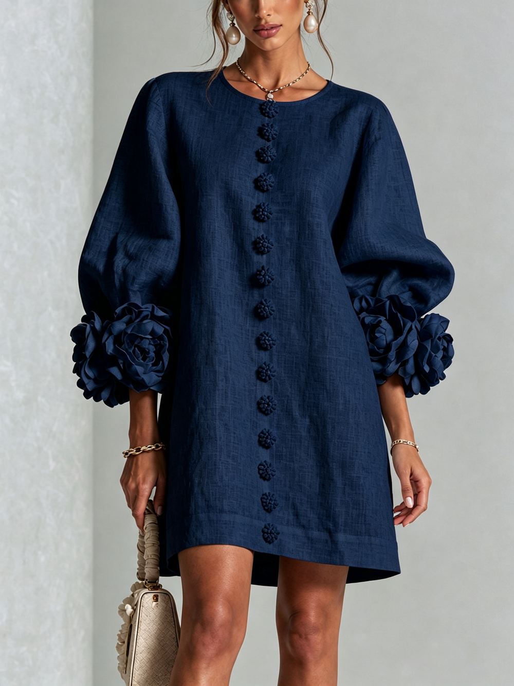 Marina relaxed mini dress in navy blue, front view with rose cuffs and floral buttons