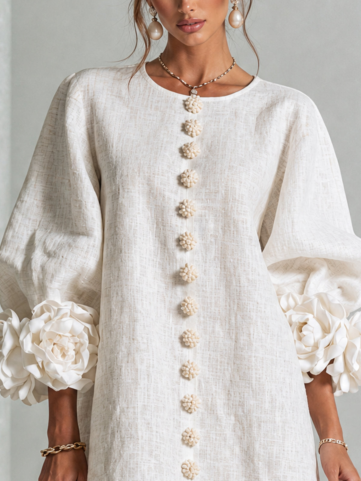 Close-up of Chiara dress flower-shaped buttons and rose cuffs