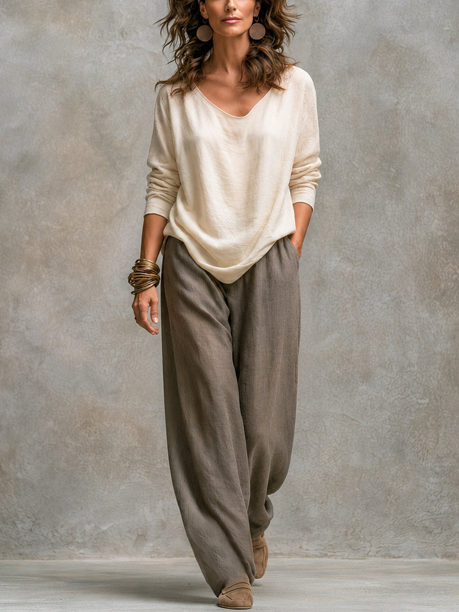 Cream scoop-neck top and grey wide-leg trousers, full-length front view