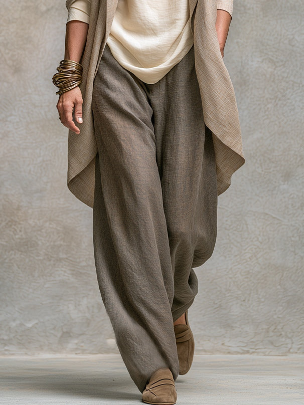 Grey wide-leg trousers of the three-piece suit, lower body view