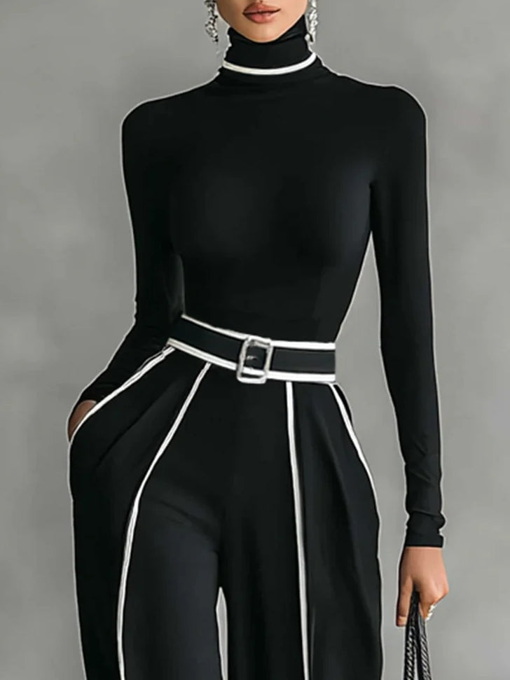 Adèle high-neck top and belt detail in black with white trim