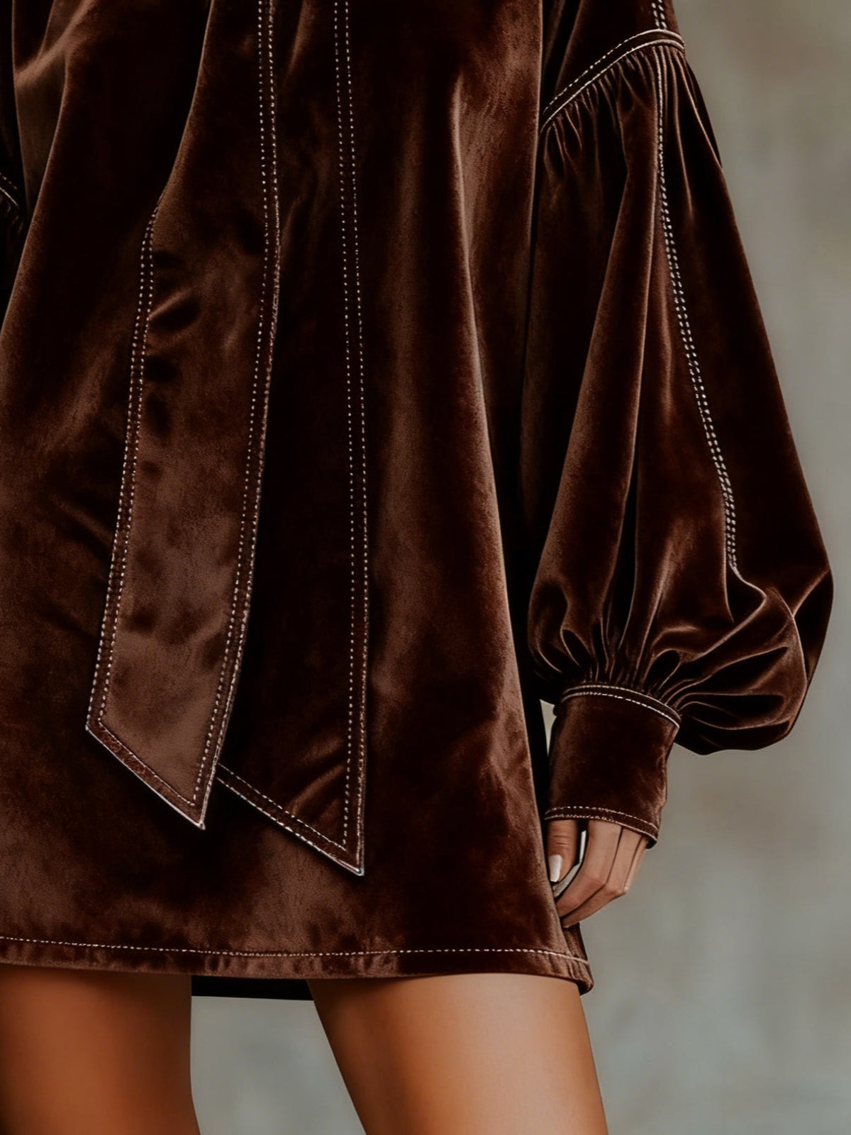 Celeste velvet mini dress in dark brown, detail of lantern sleeve and hem