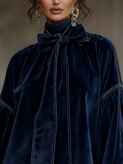 Liora dark blue velvet dress, close-up of bow and contrast stitching