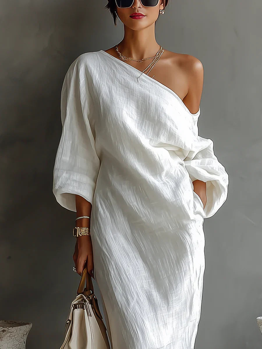 Elise maxi dress in ivory, close view of one-shoulder neckline and sleeve