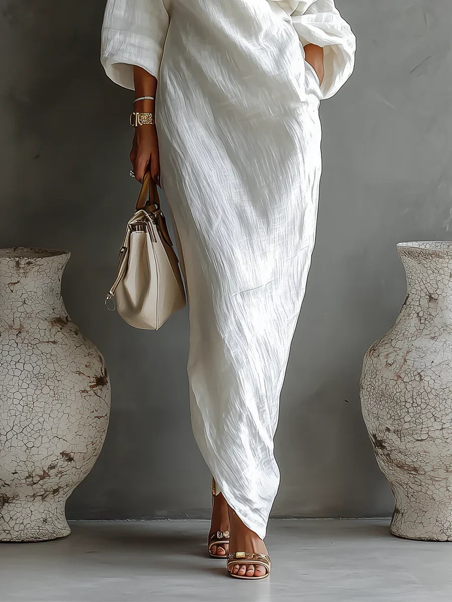Elise maxi dress in ivory, detail of textured fabric and asymmetric hem