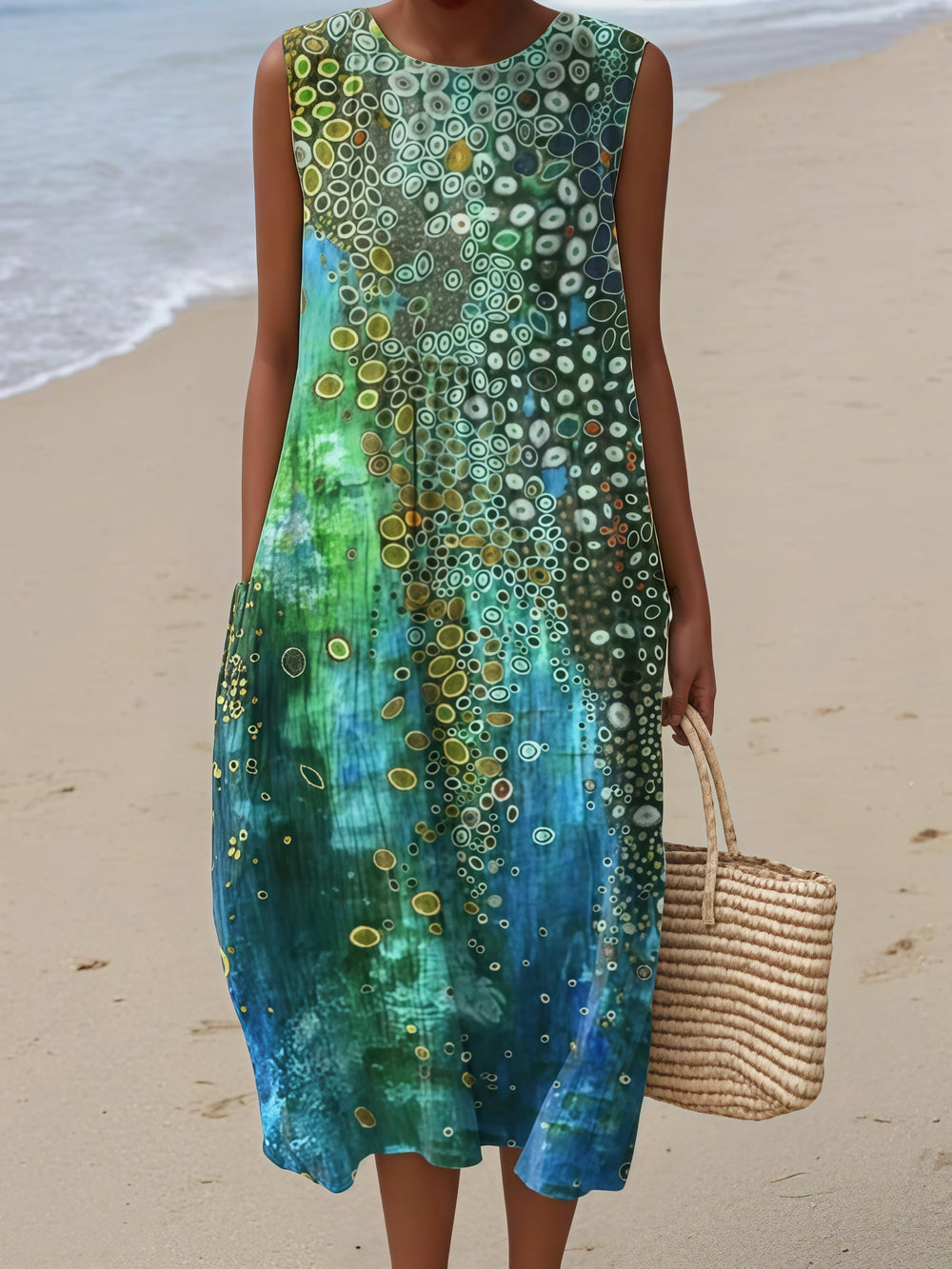 Zara sleeveless summer dress in green and blue print, full-length front view on the beach