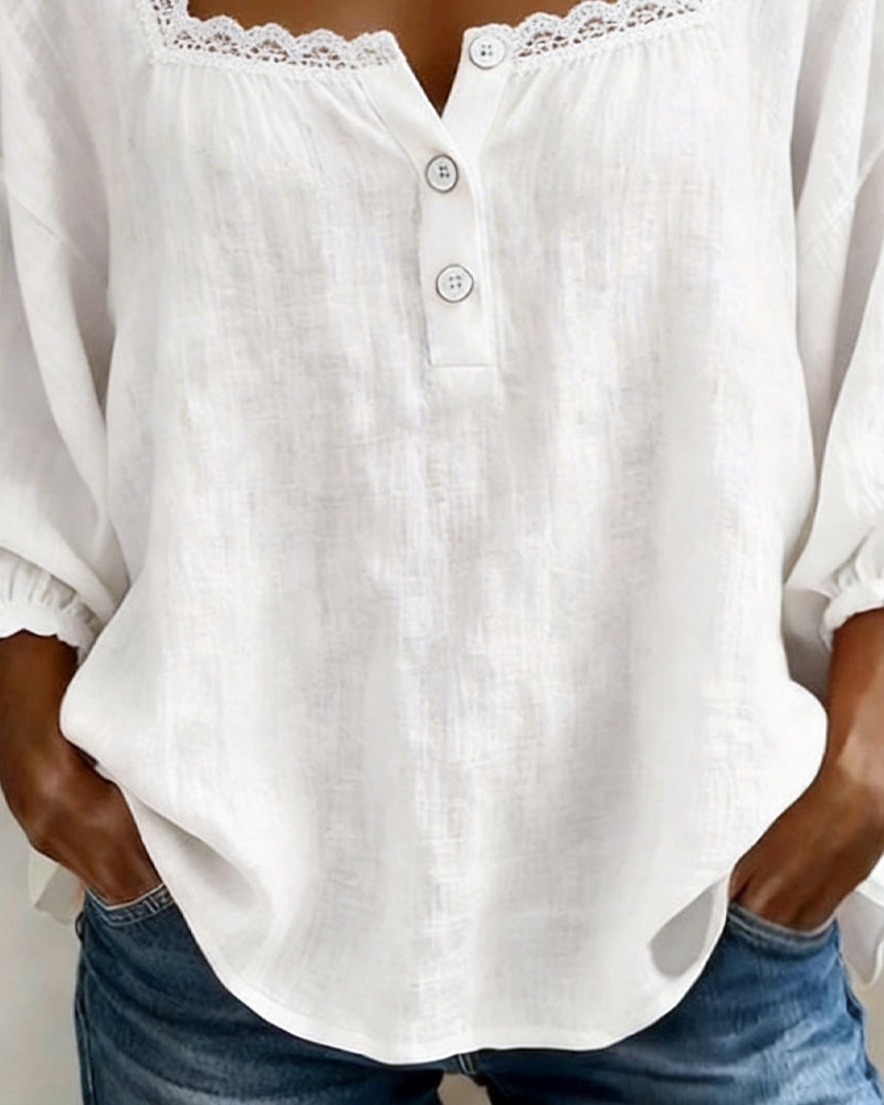 Elodie blouse in white, close view of button placket and curved hem