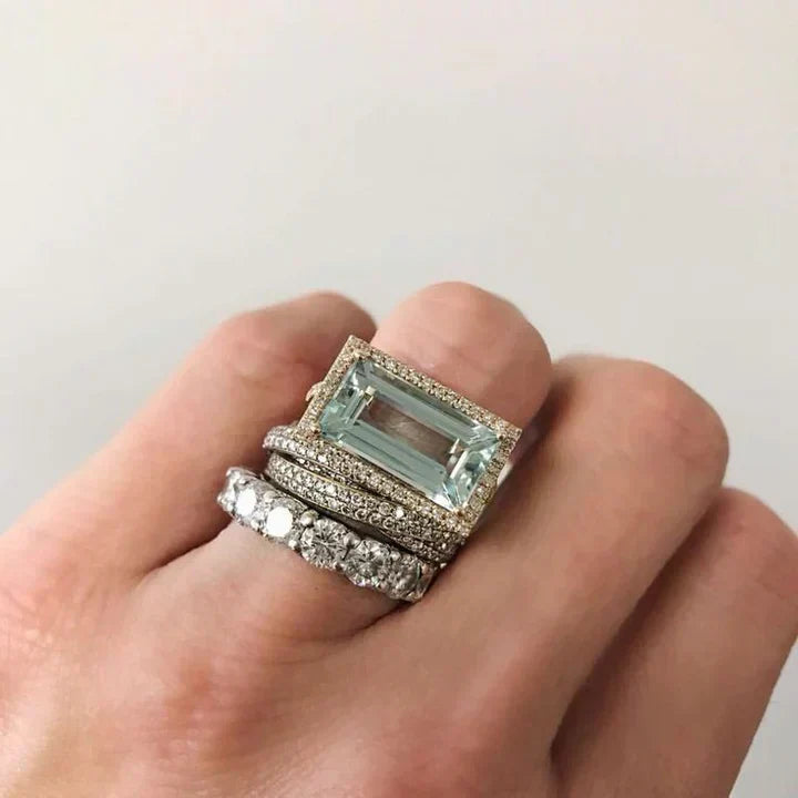 Turquoise glass ring set stacked on a hand, close-up view
