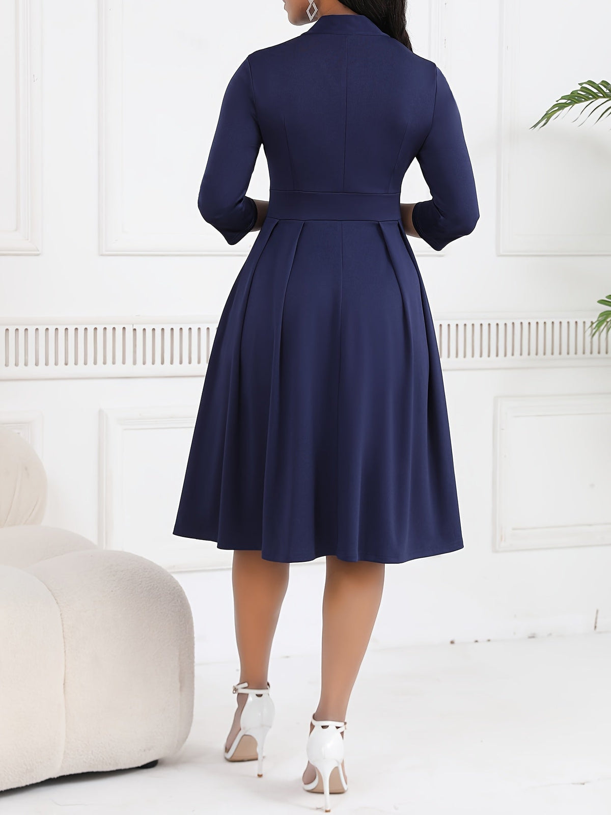 Olivia tie-waist midi dress in navy blue, back view of pleated skirt