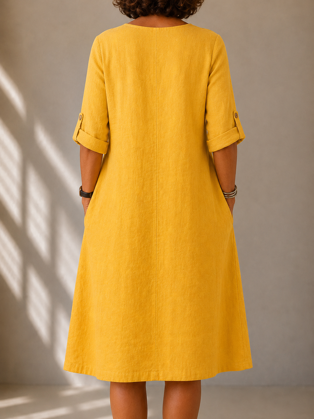 Monique flowy long-sleeve dress in mustard yellow, back view