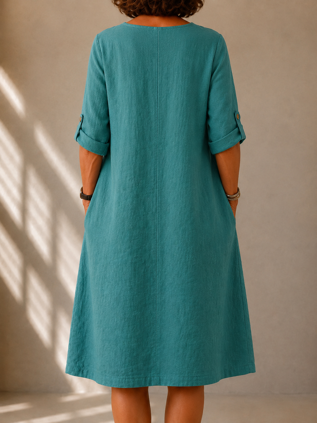 Sophie flowy elegant dress in peacock blue, back view
