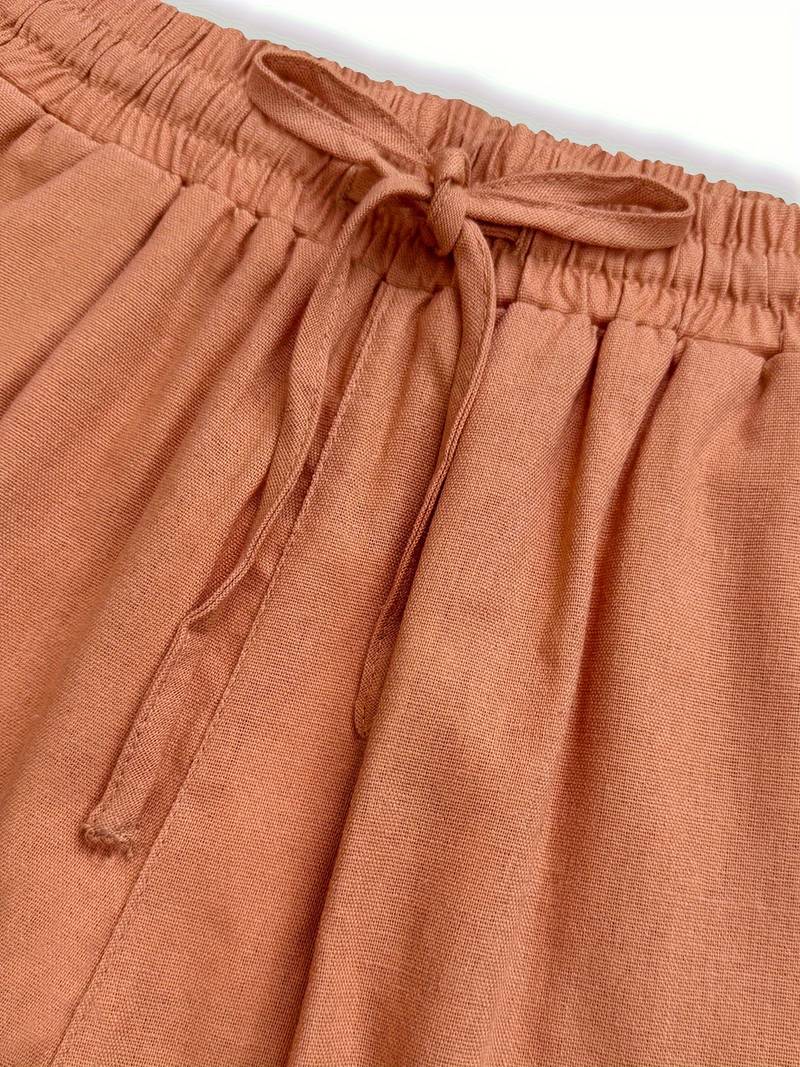 Imara trousers close-up of drawstring waistband and side pocket in salmon