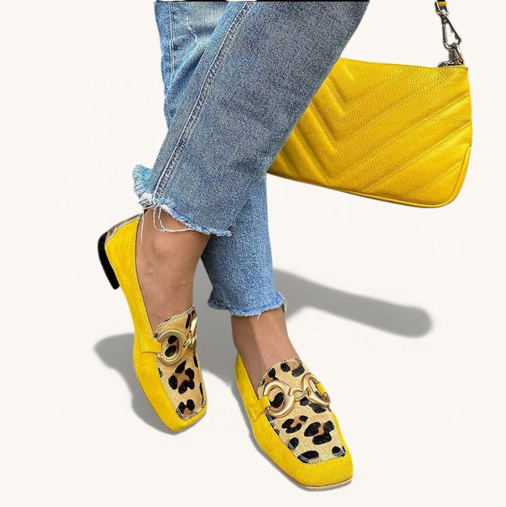 Assunta animal print loafers in yellow with gold buckle, worn with cropped jeans