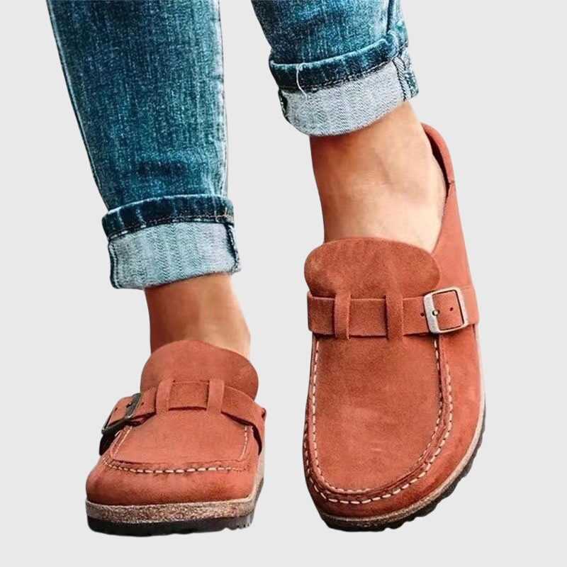 Kendra clogs in orange worn with rolled-up jeans, side view