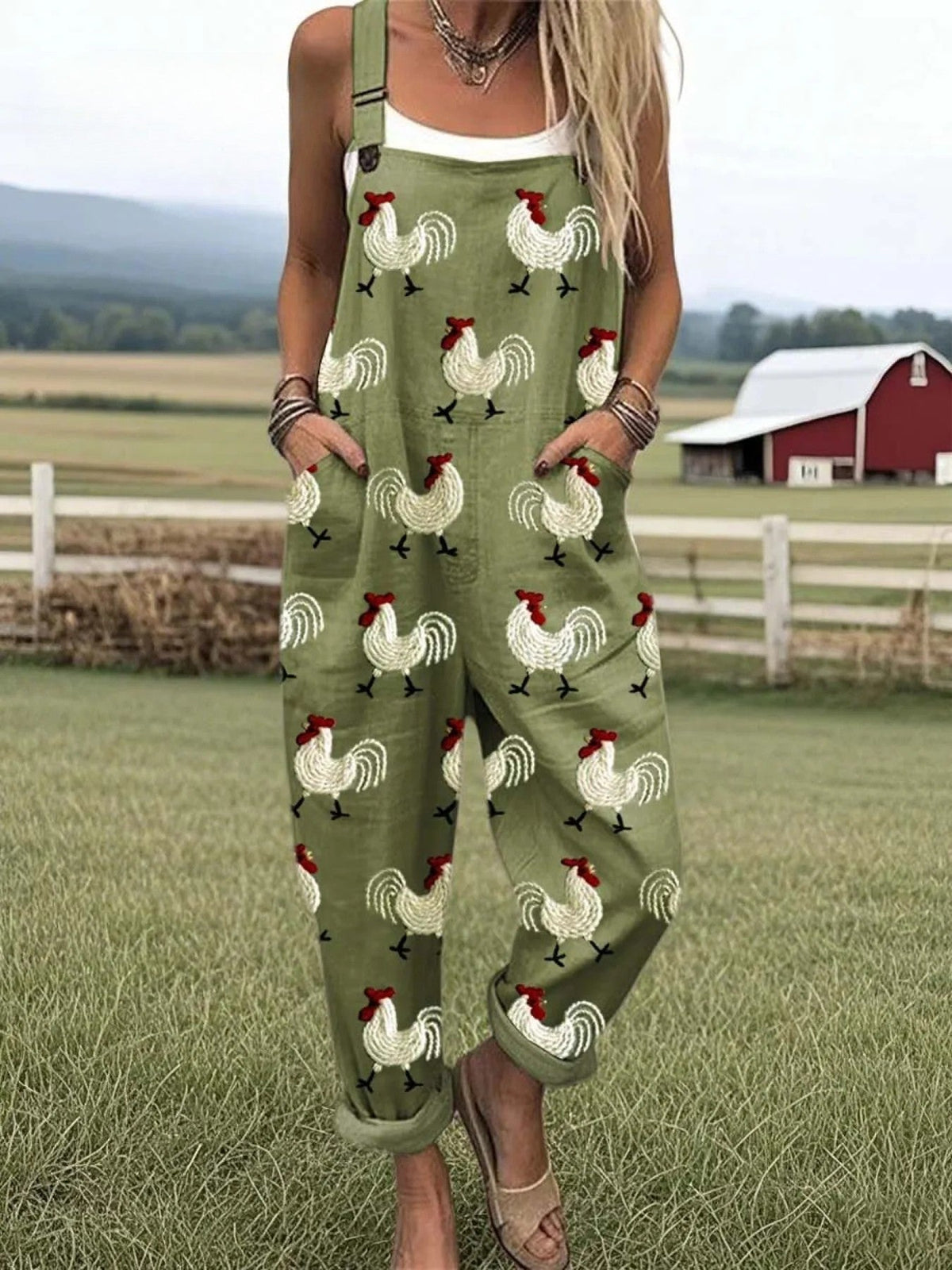 Rooster-print dungarees in olive green, full-length front view with turned-up cuffs