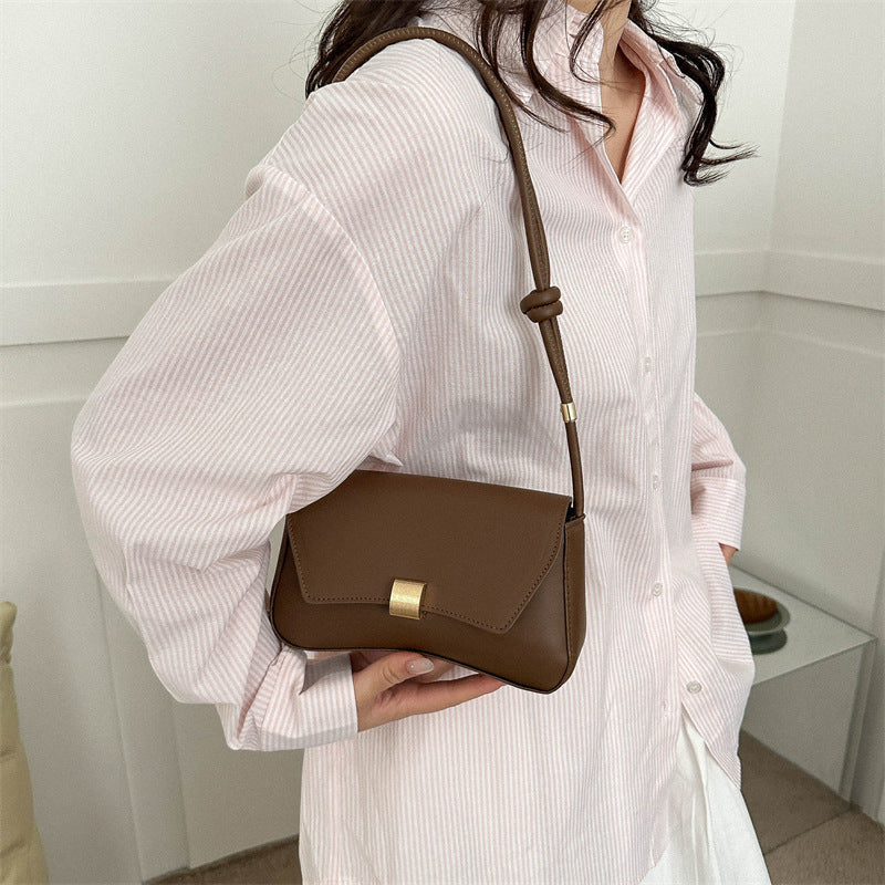 Cécile mini shoulder bag in brown worn on the shoulder