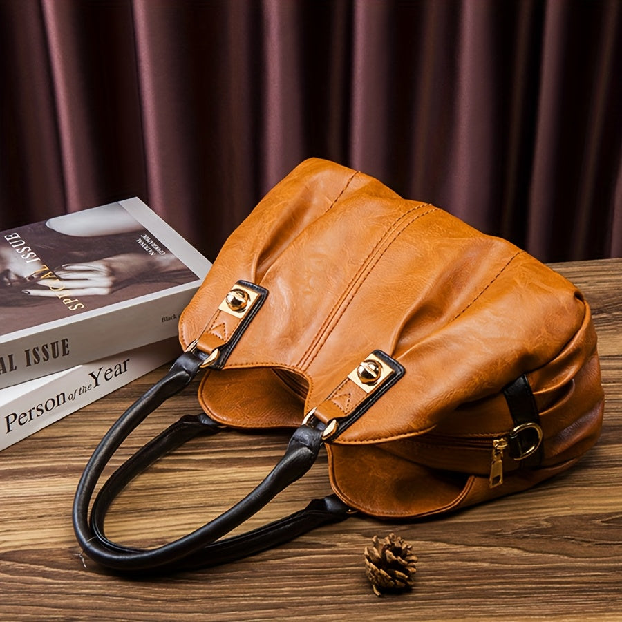 Zoe tote in tan brown, close view of pleating, black handles and gold clasps