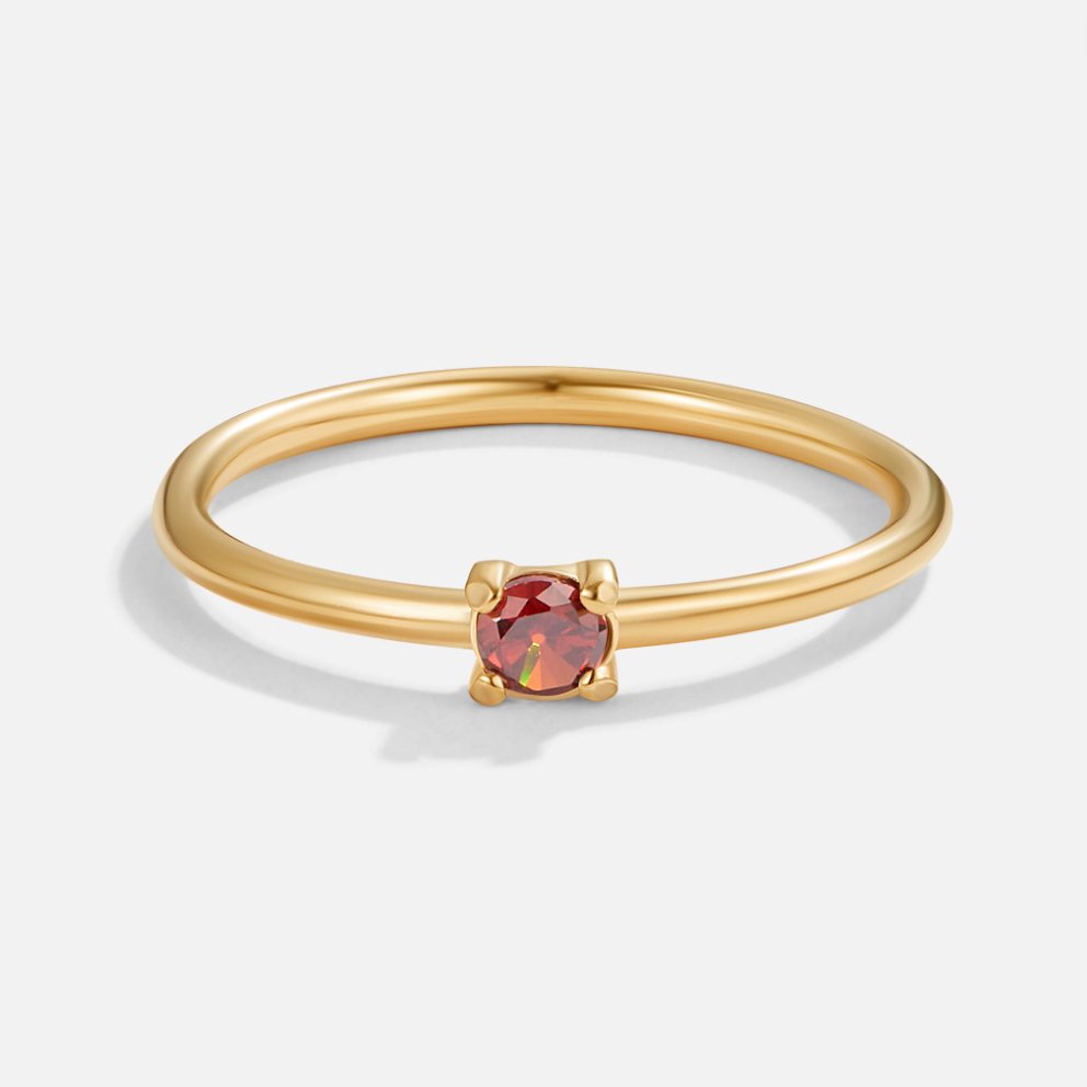 Gold birthstone ring with red garnet stone, close front view