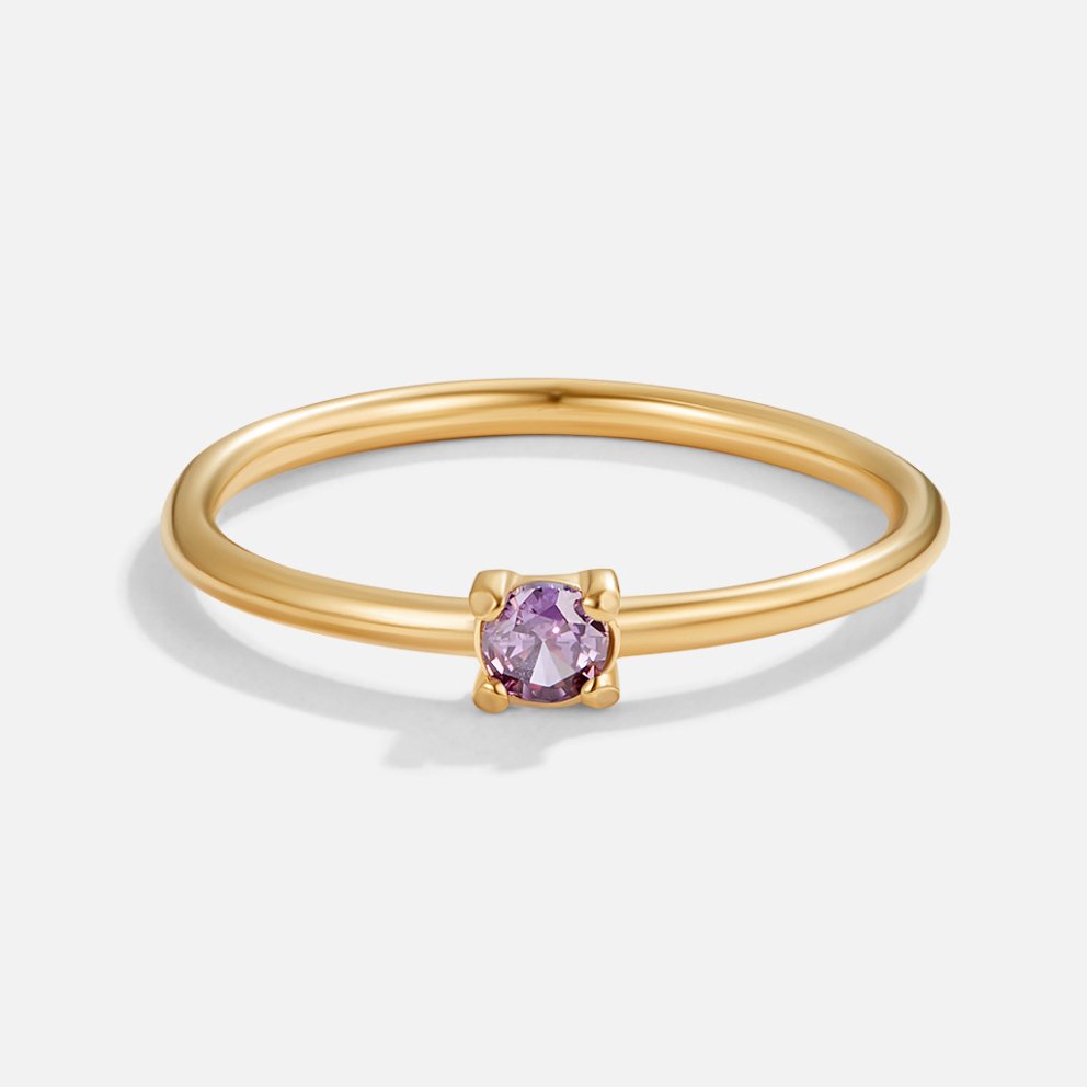 Gold birthstone ring with purple amethyst stone, close front view