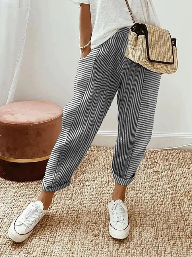 Cosette striped trousers in black and white, front view with trainers