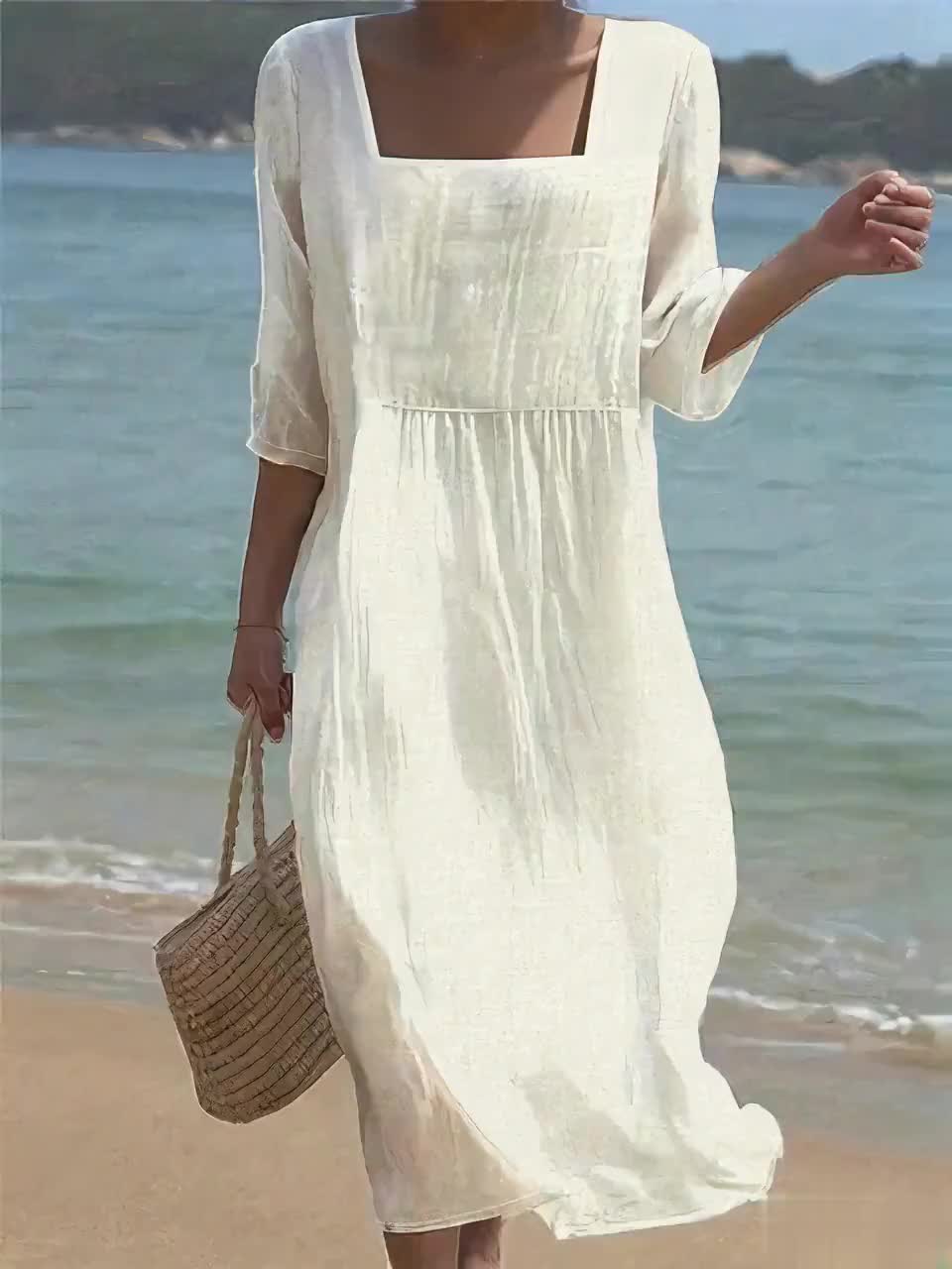 White casual midi dress with square neckline, worn on the beach, front view