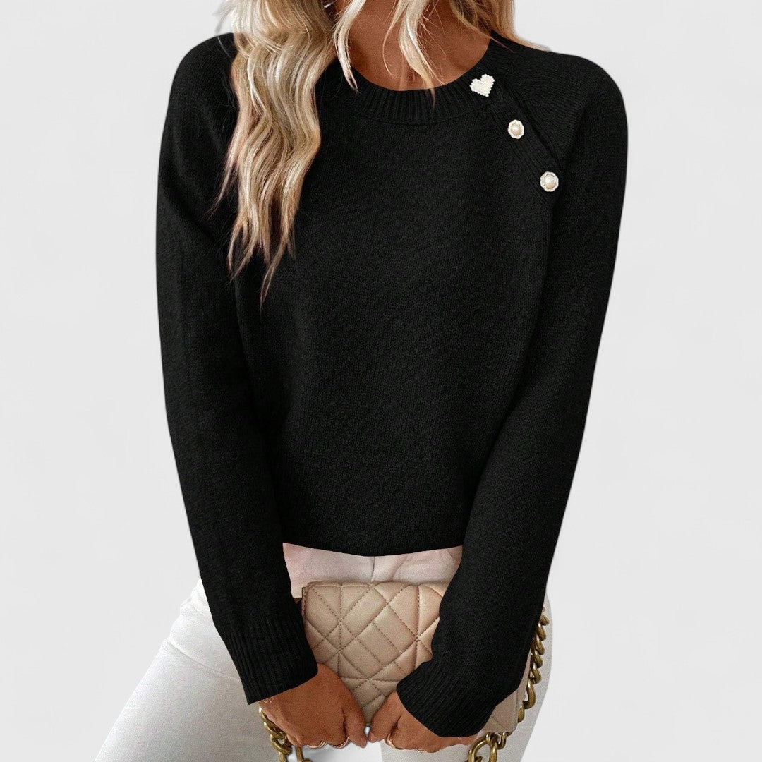 Mira knit sweater in black, front view with pearl shoulder buttons