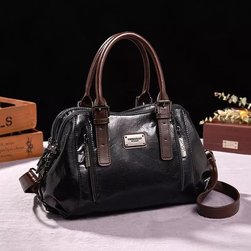 Eveline chic handbag in black, front view with shoulder strap