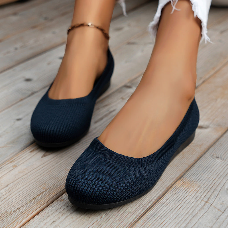 Anna knitted slip-on shoes in navy blue, worn front view