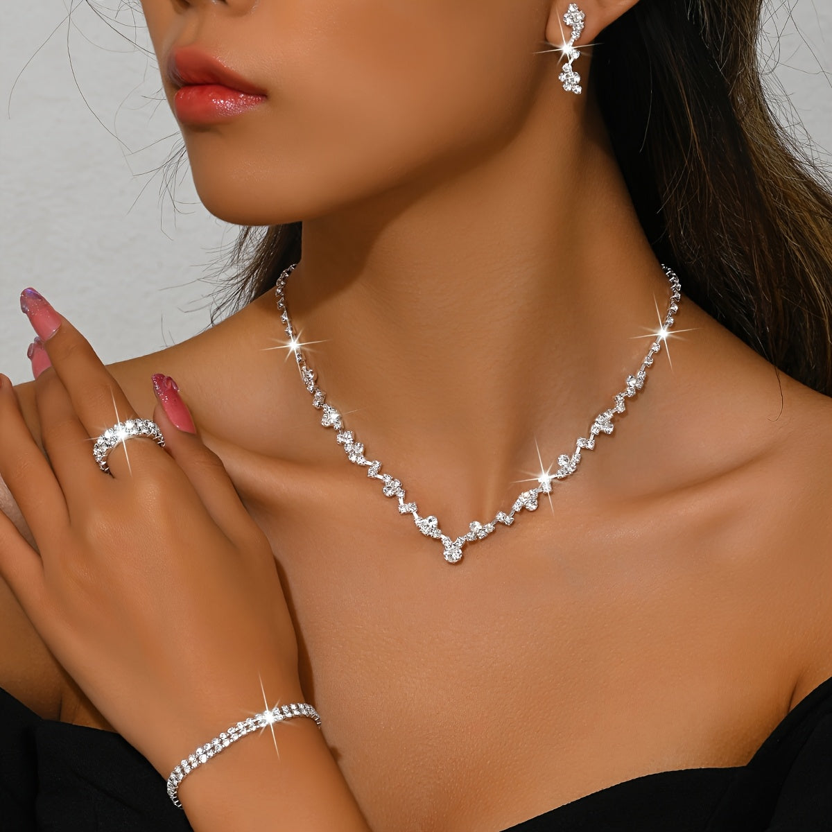 Crystal jewellery set in silver, necklace and earrings worn close-up