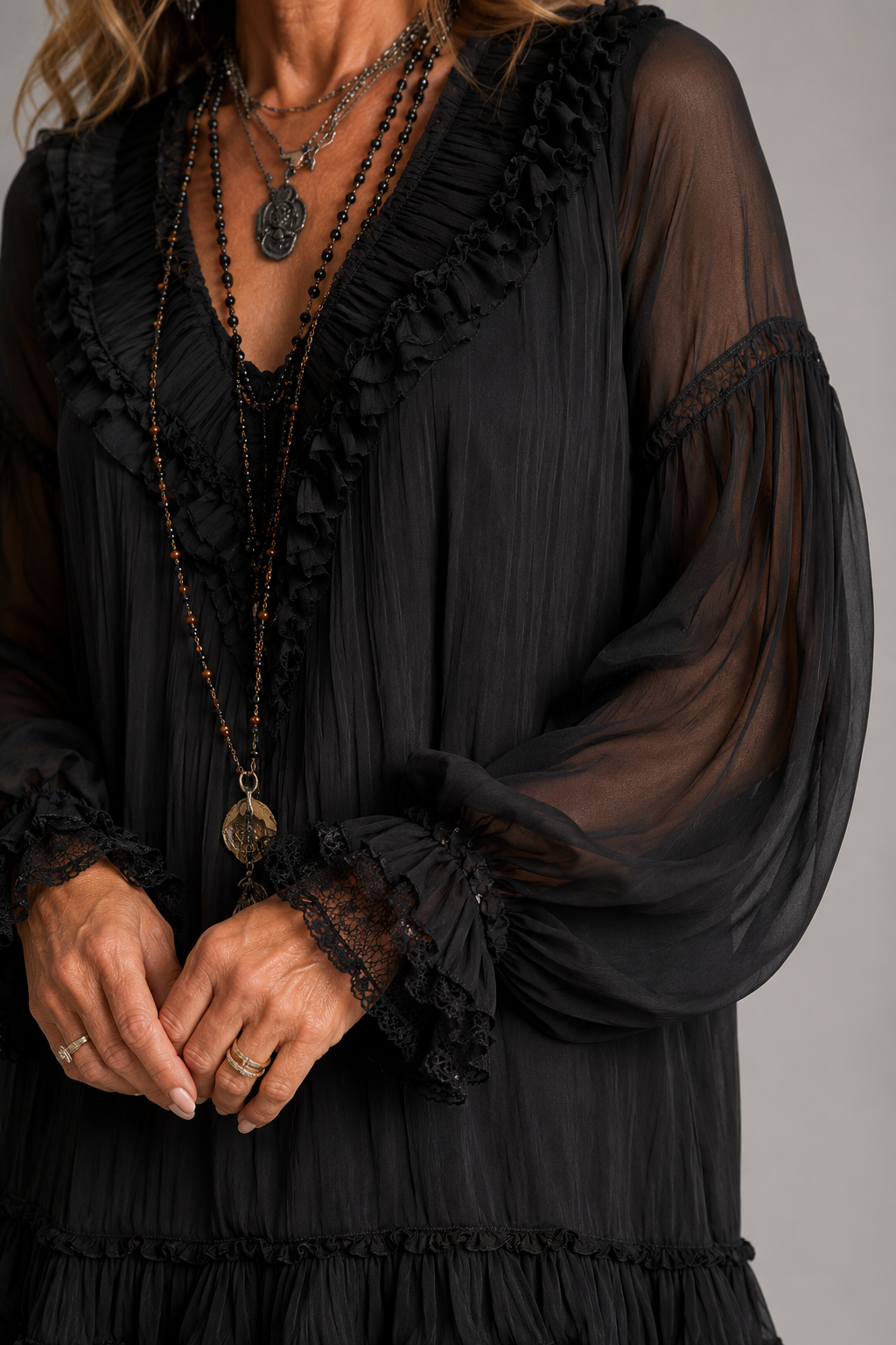 Oriella mini dress in black, close-up of lace neckline and sleeve cuffs