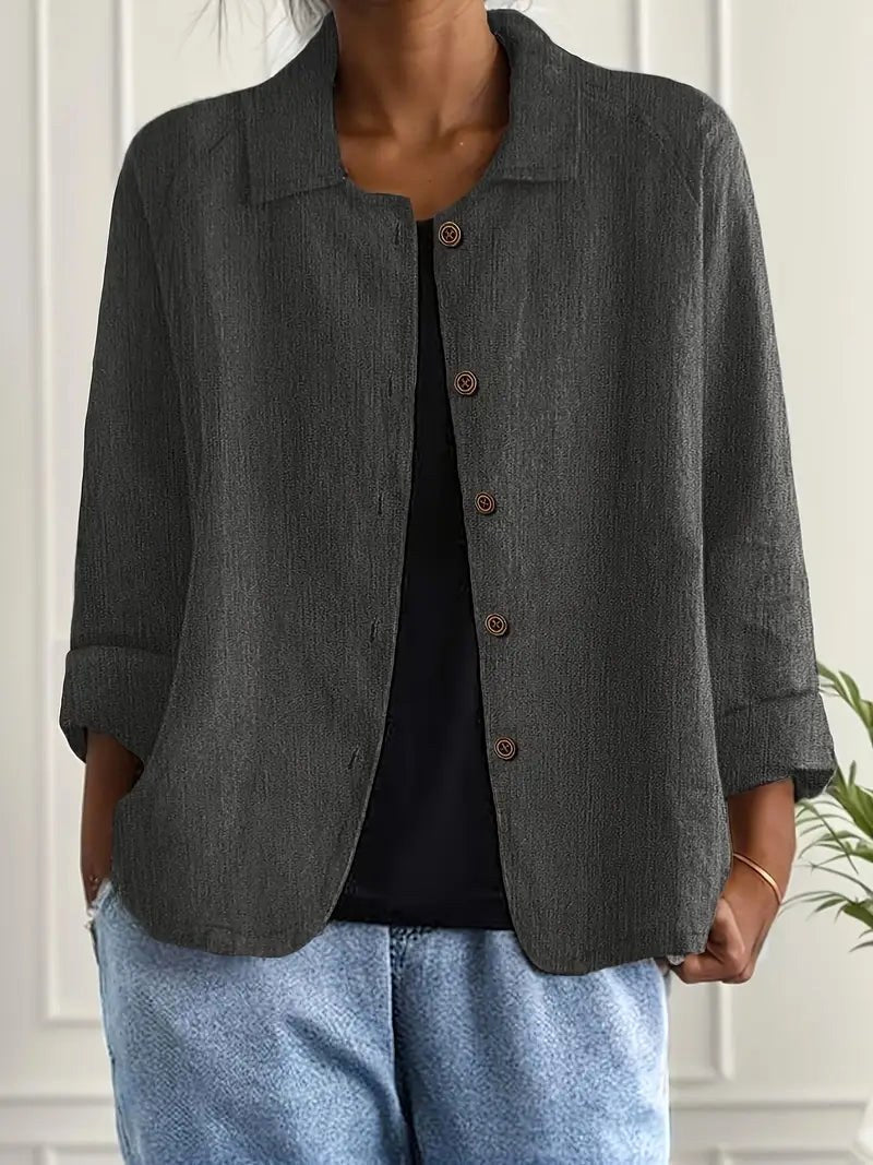 Zelina button-through blouse in dark grey, worn open over a black top with denim