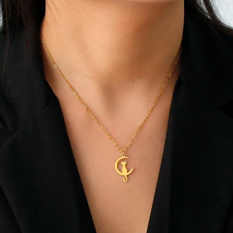 Cat and moon pendant necklace in gold, worn at the collarbone