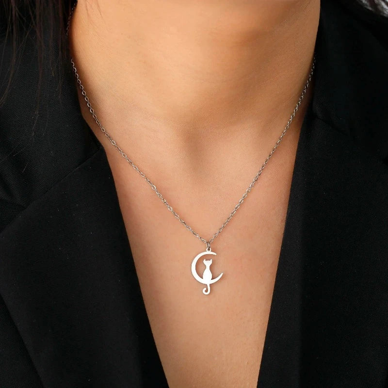 Cat and moon pendant necklace in silver, worn at the collarbone