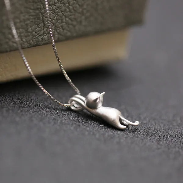 Cat pendant necklace in silver, close-up of the sculpted cat and fine chain