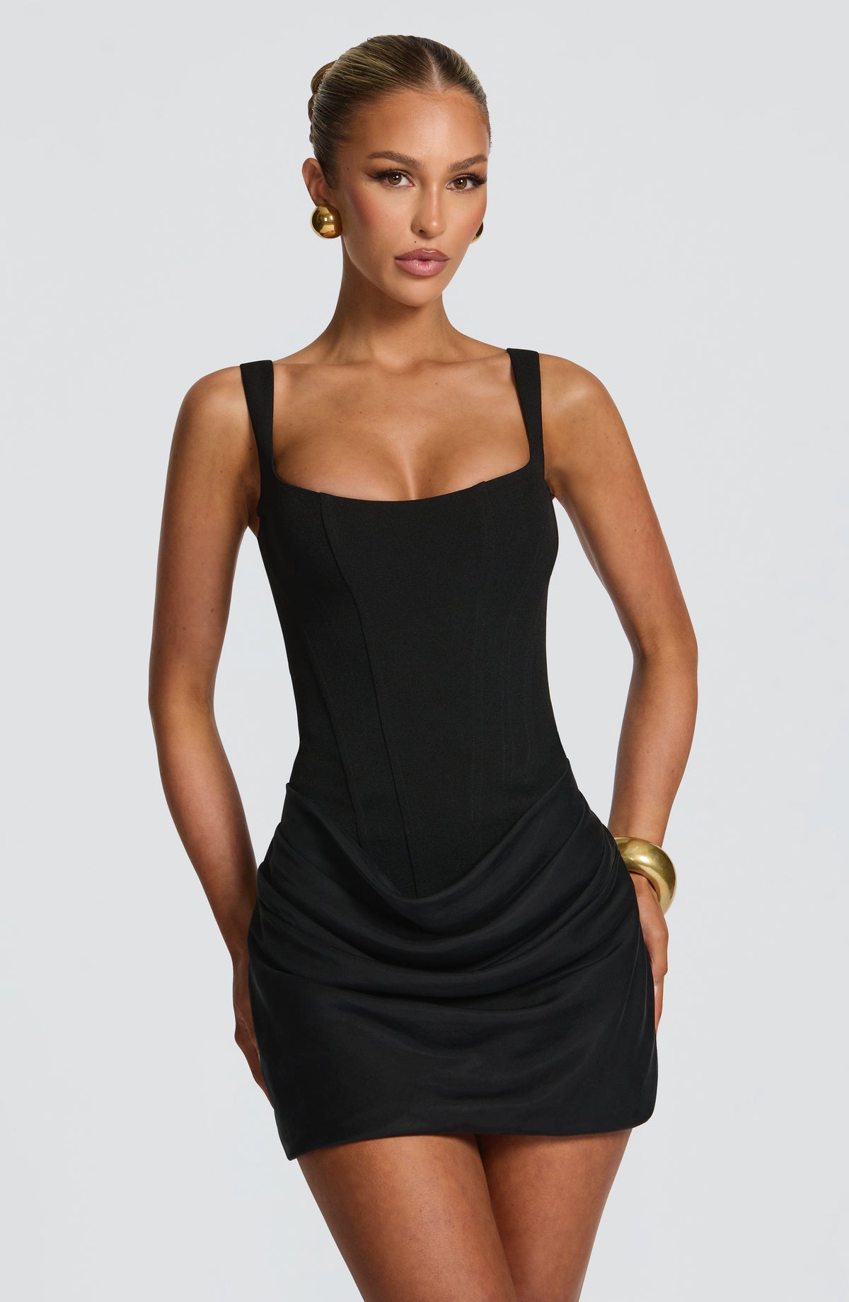 Cornelia black mini dress, front view with corset bodice and draped skirt