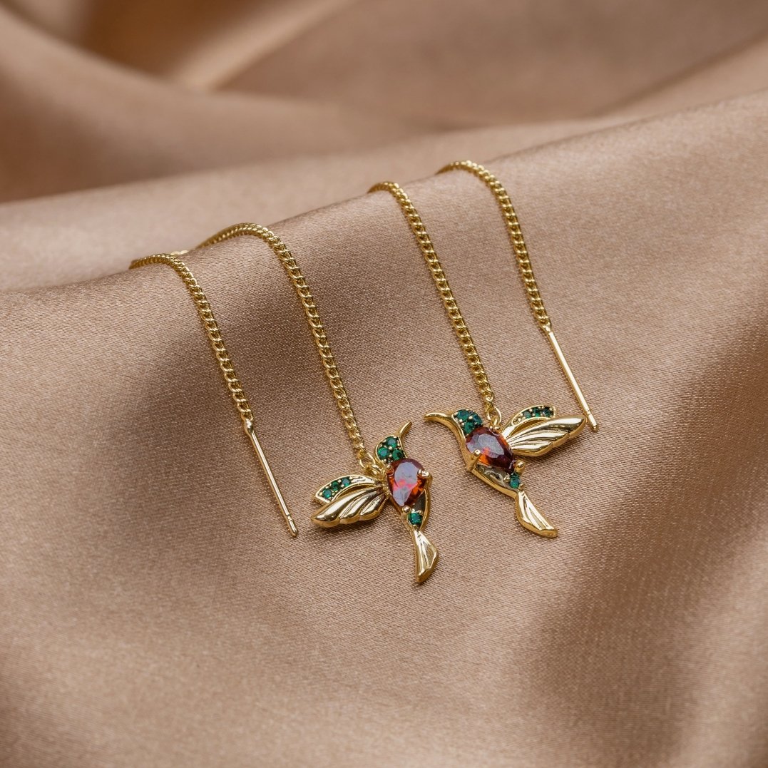Stefanie gold threader earrings with red and green stone hummingbird detail