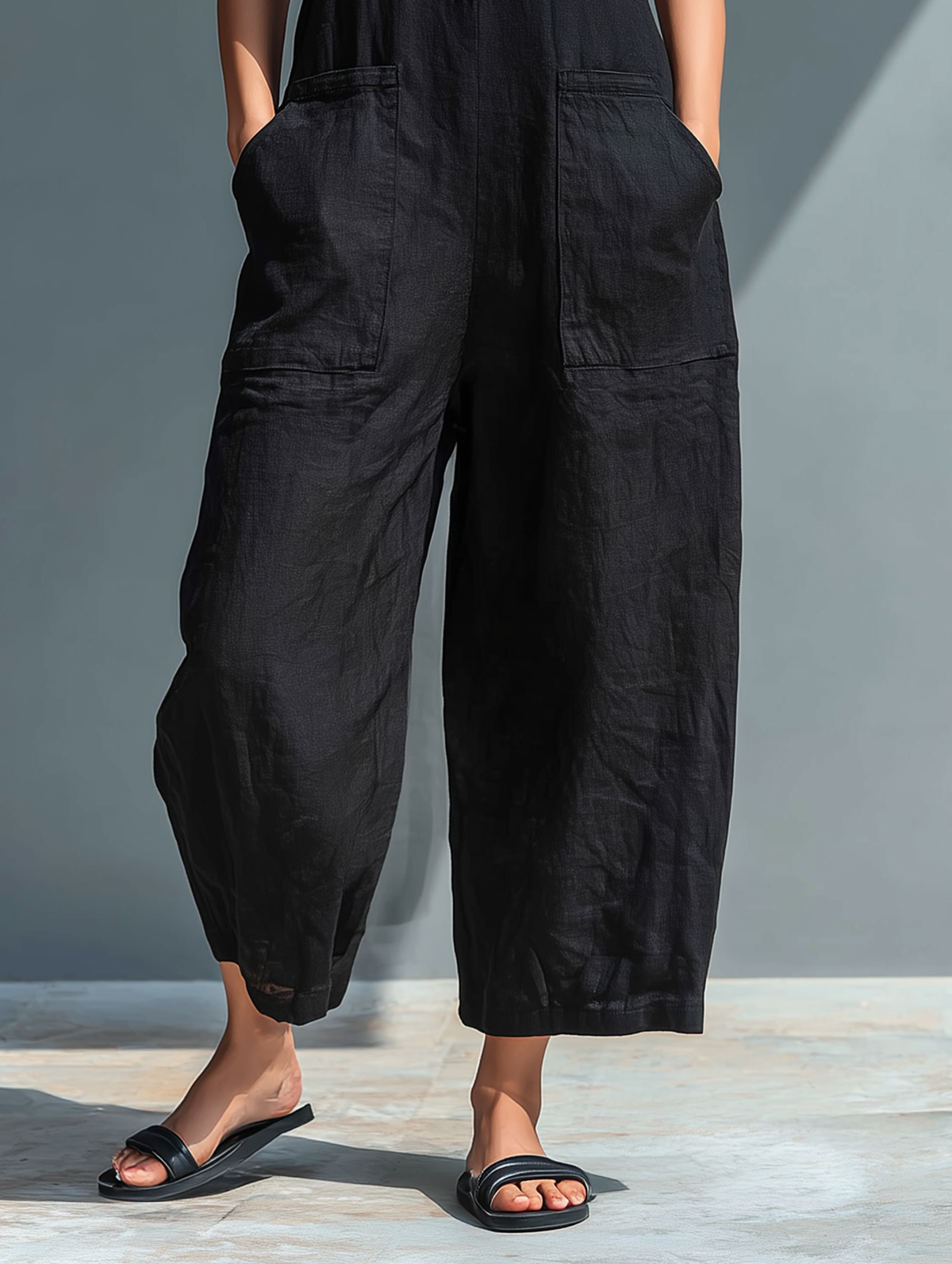 Teresa jumpsuit in black, close-up of large front pockets and cropped wide leg