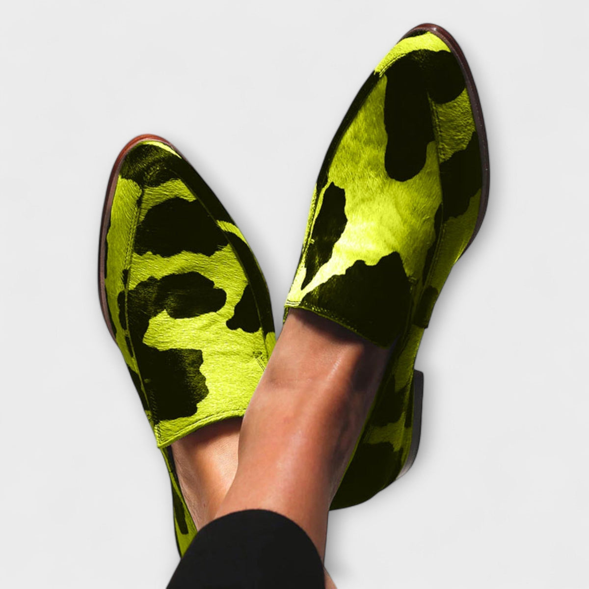 Serena cow print loafers in green, close-up worn view