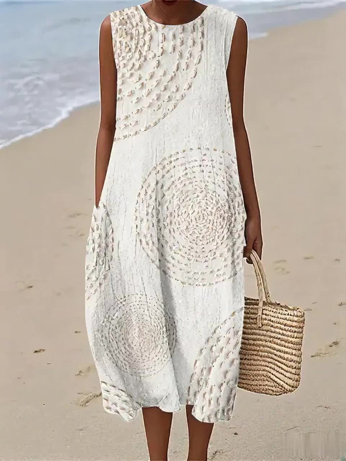 Oplena sleeveless dress in white with textured circular print, full-length front view