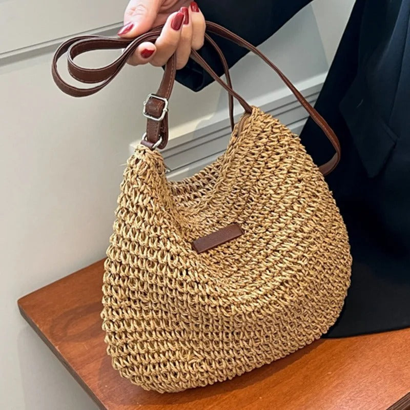 Woven shoulder bag in khaki, held by the strap