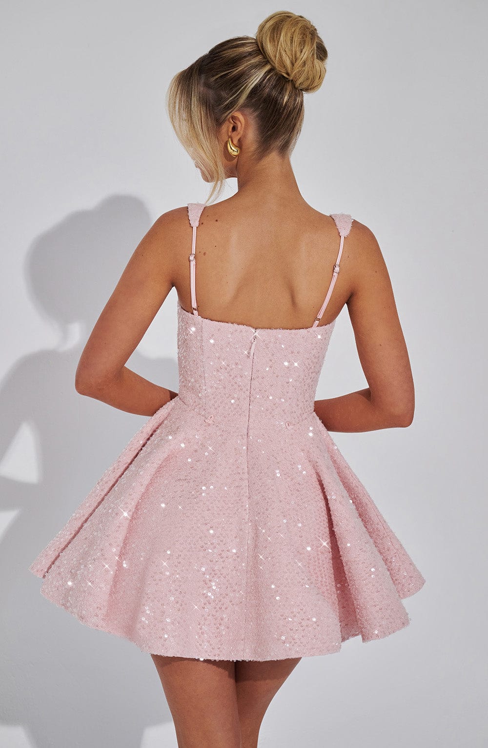 Romy pink sequin mini dress, back view of flared skirt