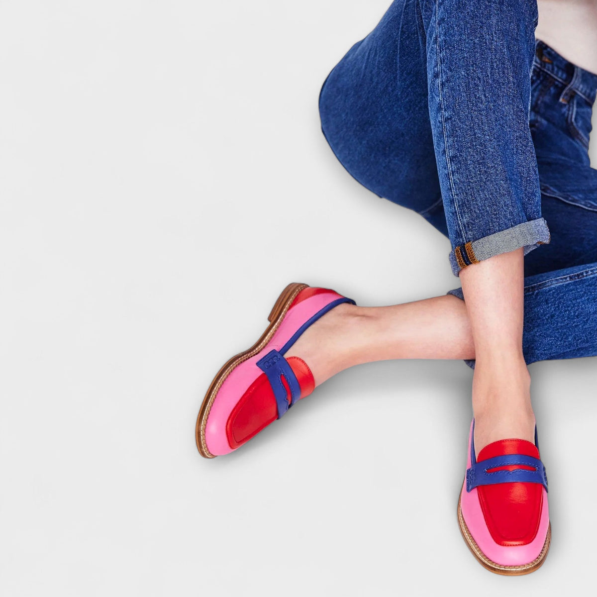 Vivian patchwork loafers in pink, red and blue, worn with turned-up jeans