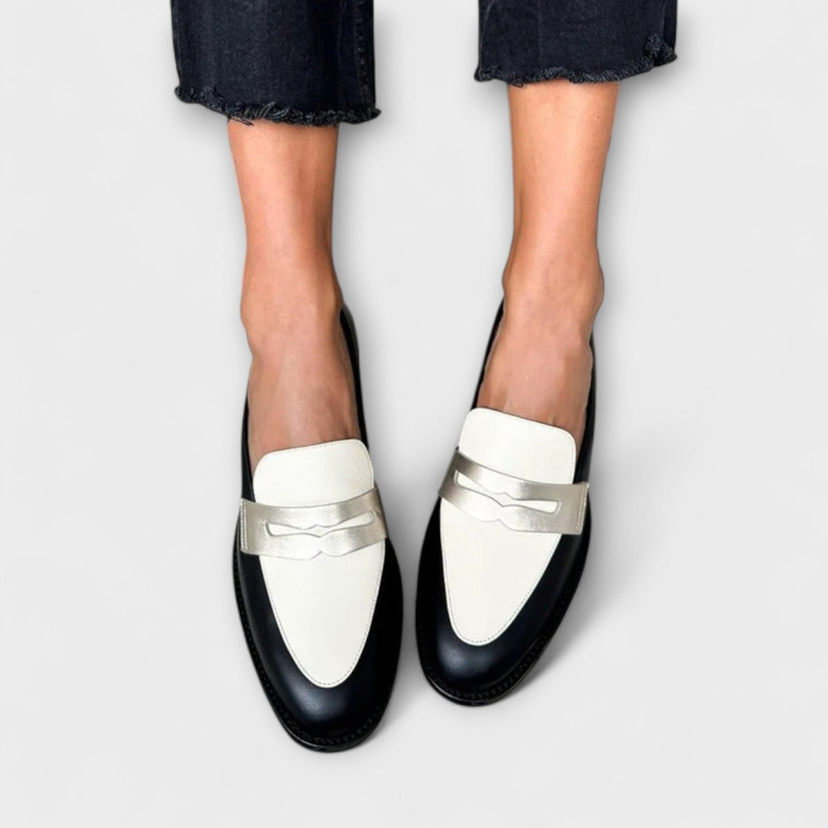 Iris black and ivory loafers, front view worn with dark trousers