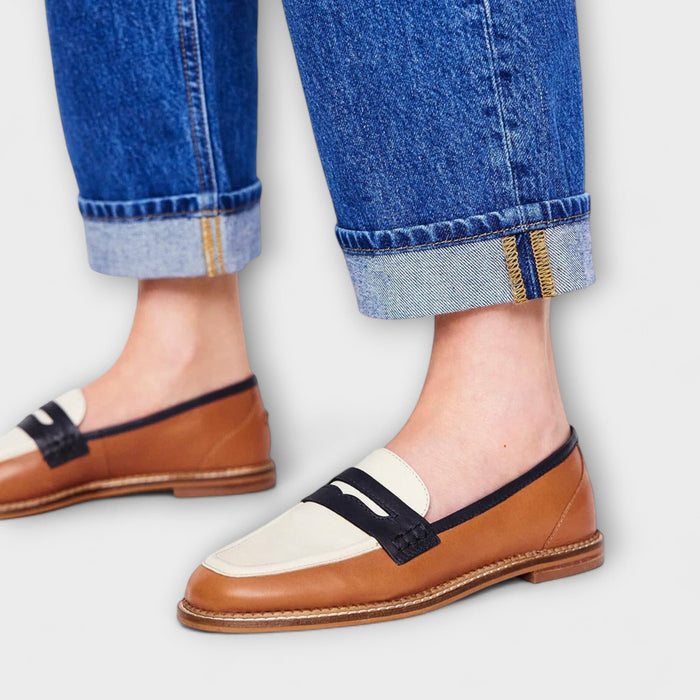 Amelie classic brown loafers in tan with navy and cream saddle panel, worn with jeans