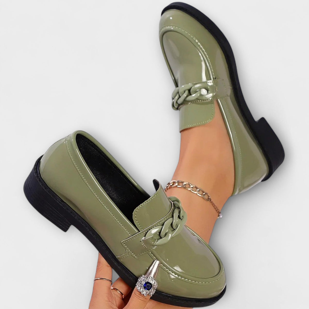 Delia chain loafers in green, pair shown from above