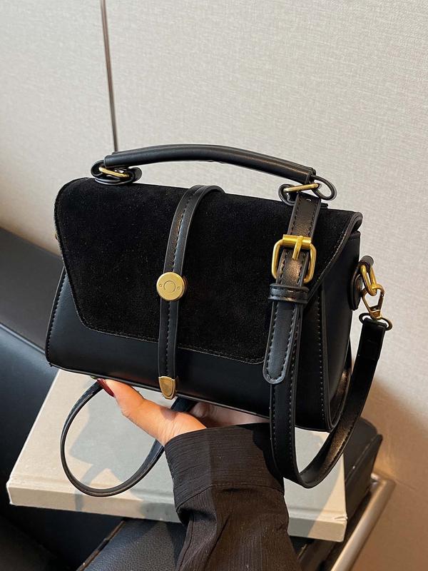 Alwina contrast stitching shoulder bag in black, front view with top handle