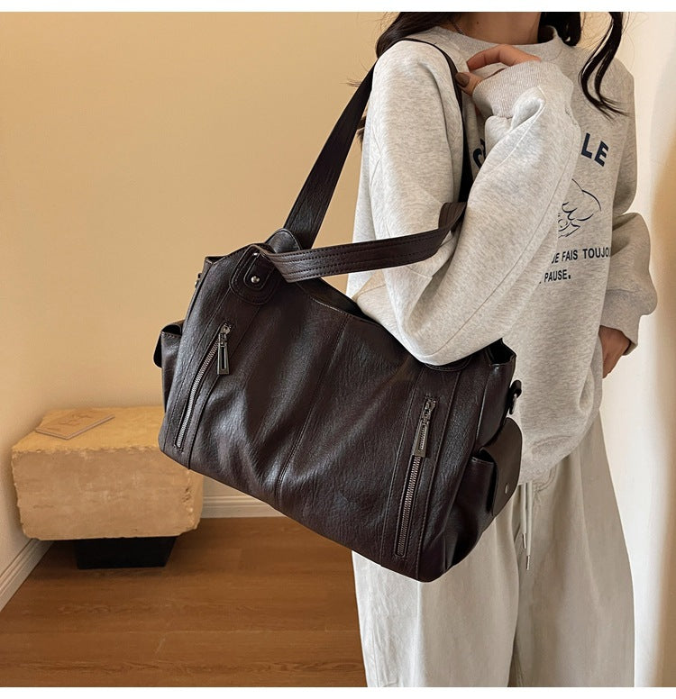 Rae classic handbag in coffee brown carried on the shoulder