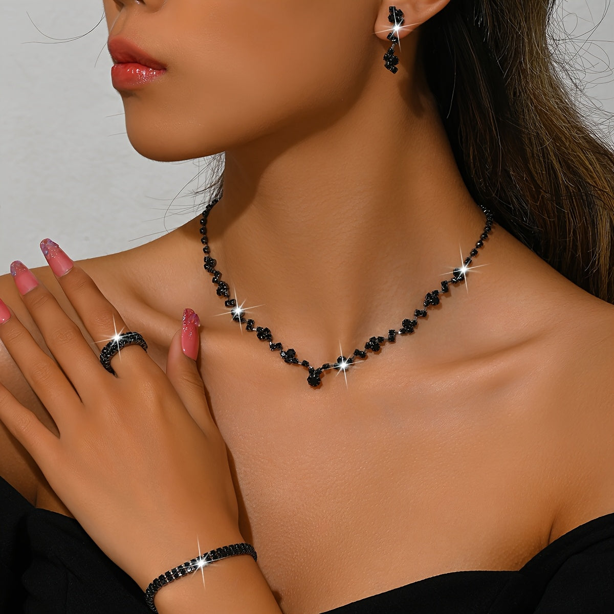Crystal jewellery set in black, necklace, ring and bracelet worn close-up