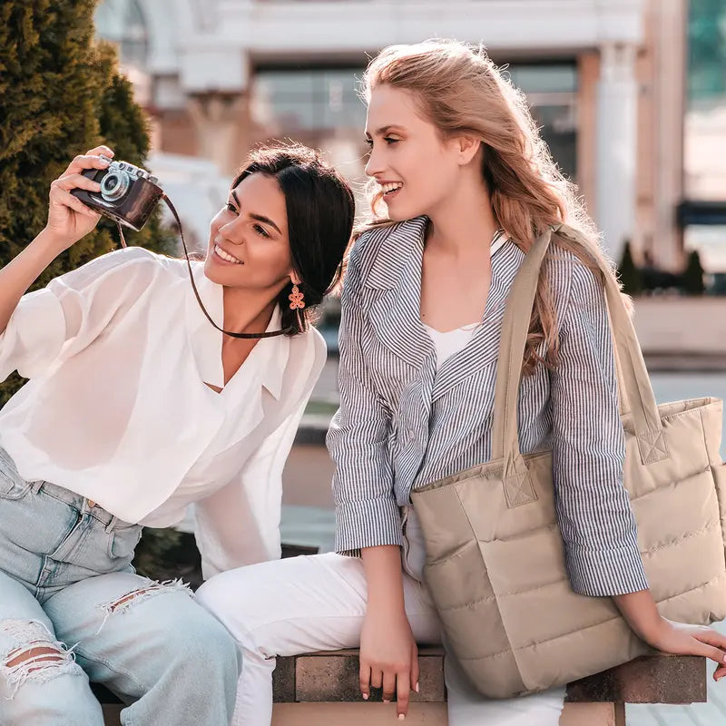 Maison Puff padded tote bag in beige carried on the shoulder outdoors