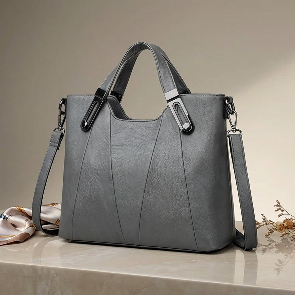 Sienna handbag in grey styled on a marble surface